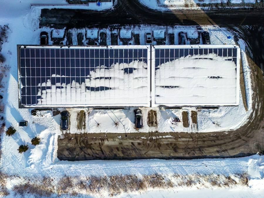 Rooftop solar panels partially covered in snow, representative image