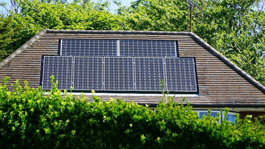 Building with rooftop solar panels, representative image
